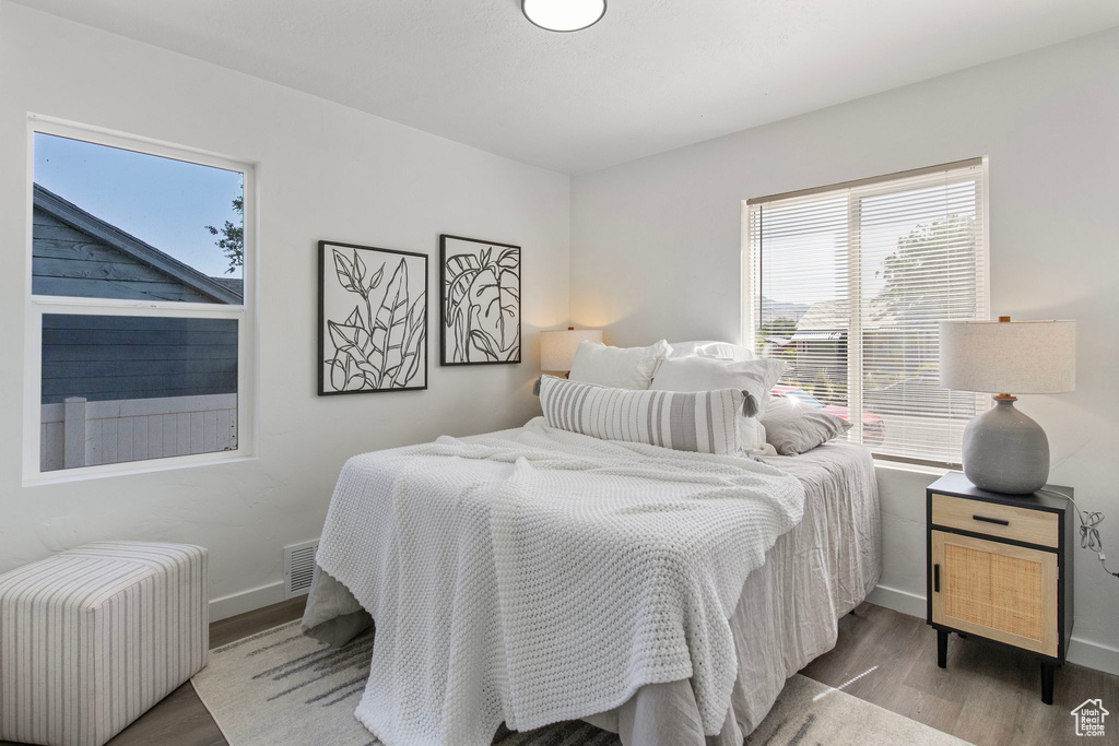 Bedroom with radiator and wood finished floors