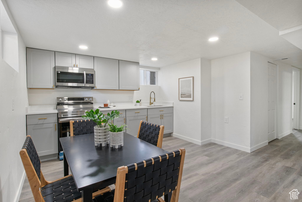 Dining area with light wood-style flooring and recessed lighting