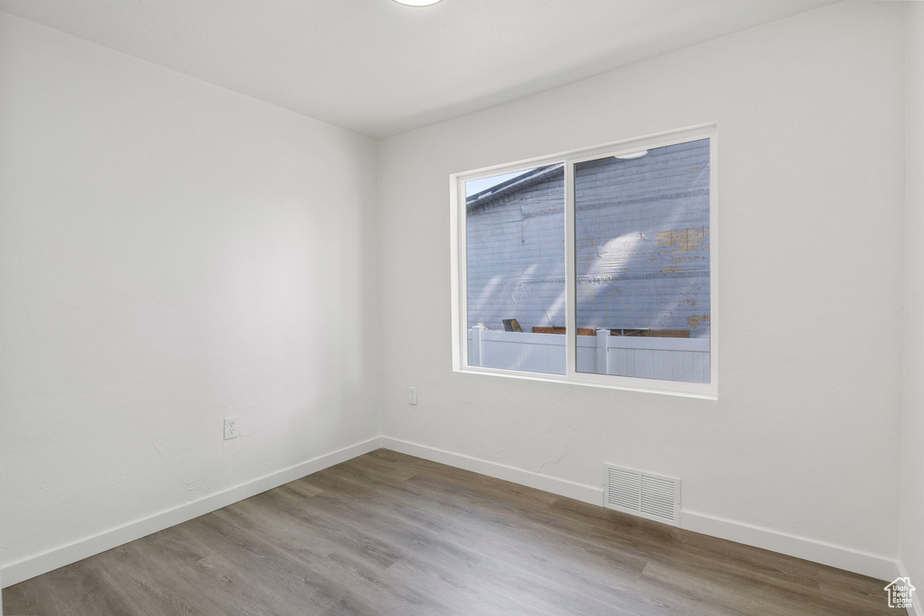 Empty room with baseboards and wood finished floors