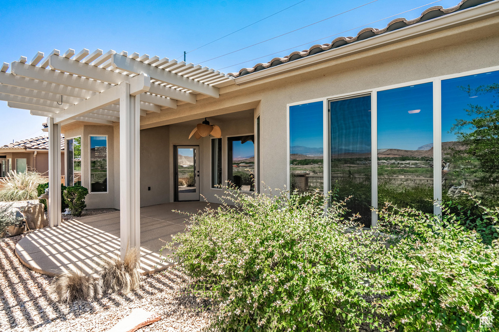 View of patio featuring a pergola and ceiling fan