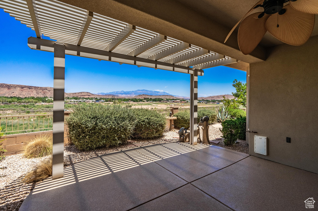 View of patio / terrace with a mountain view, a ceiling fan, and a pergola