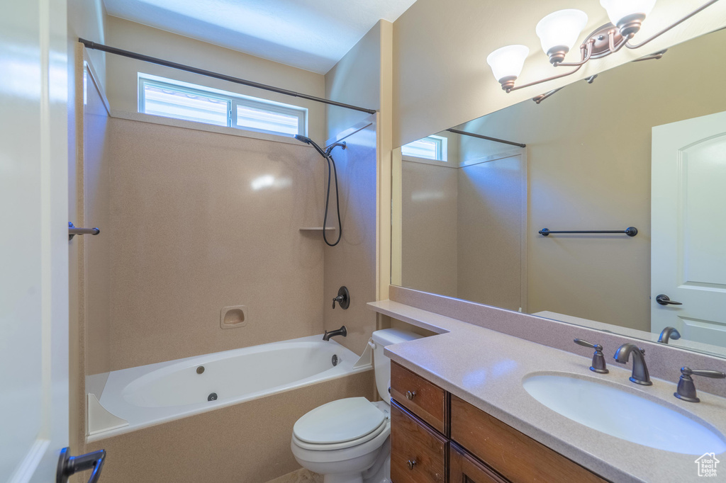 Full bathroom featuring vanity, shower / bath combination, and a chandelier