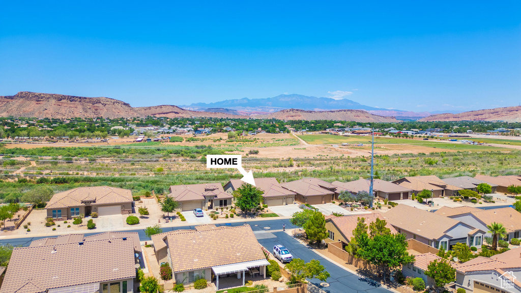 Aerial view of residential area featuring a mountainous background