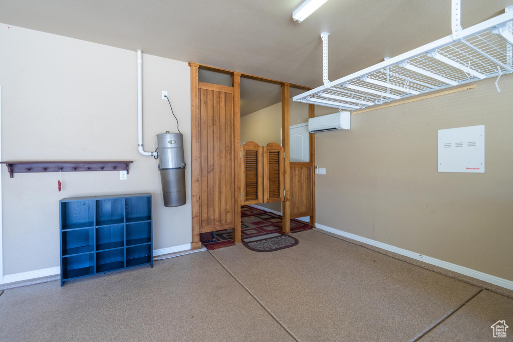 Garage with a wall mounted AC and a central vacuum unit