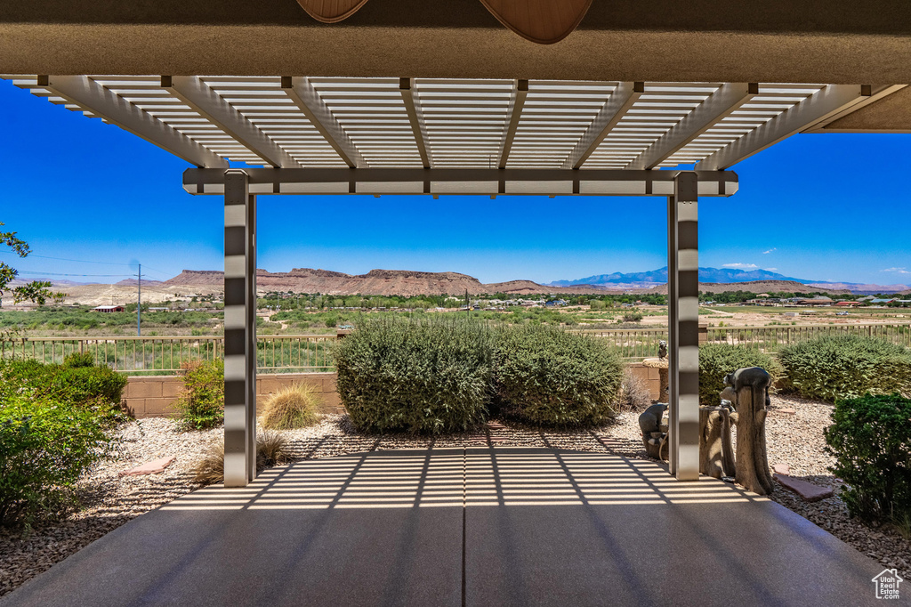 View of patio with a mountain view and a pergola