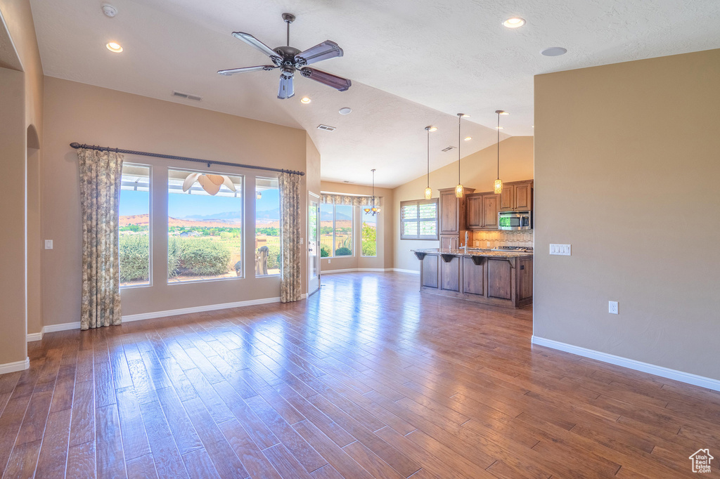 Unfurnished living room with ceiling fan, dark wood-style floors, recessed lighting, and high vaulted ceiling