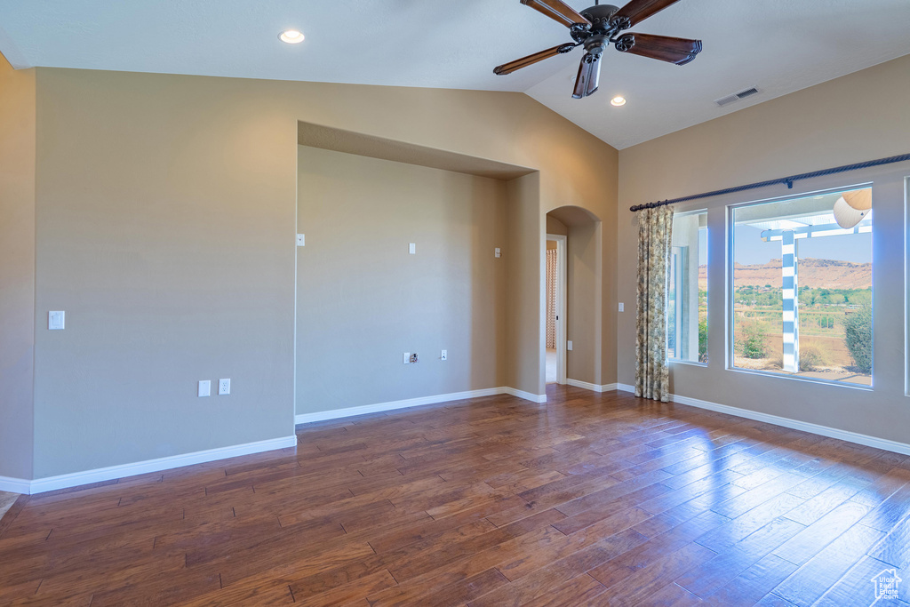 Spare room with arched walkways, ceiling fan, dark wood-style floors, lofted ceiling, and recessed lighting
