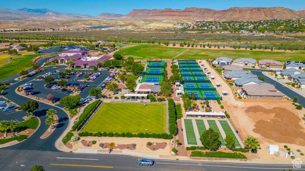 Bird\'s eye view of a mountainous background and a golf course