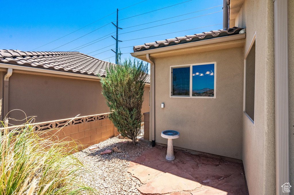 View of property exterior featuring a tiled roof and stucco siding