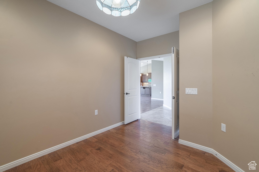 Unfurnished room with wood finished floors and baseboards