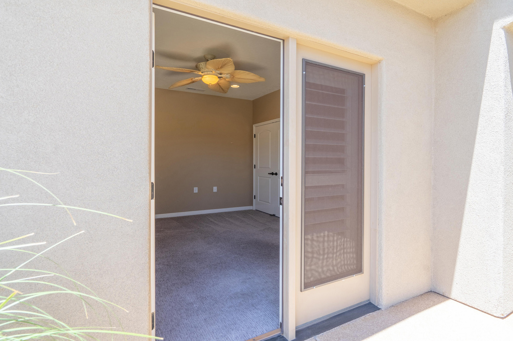 Property entrance featuring stucco siding