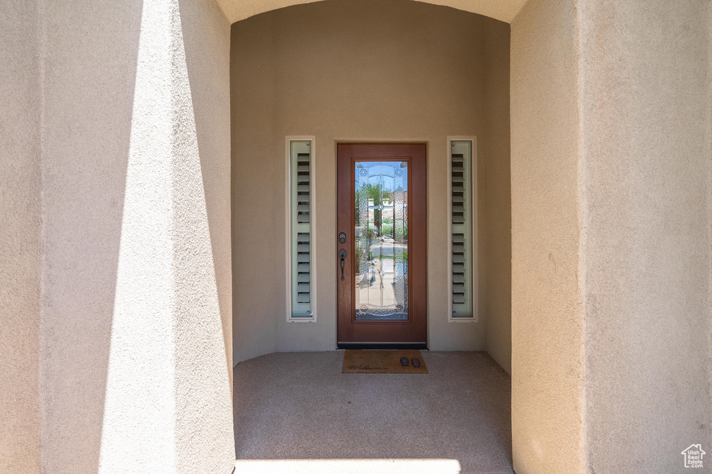 Doorway to property with stucco siding