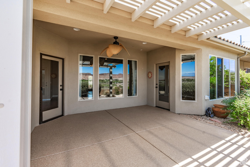 View of patio / terrace with ceiling fan and a pergola