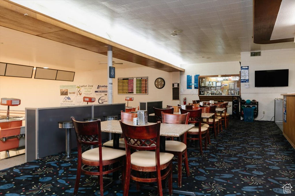 Dining space with carpet floors and a dry bar