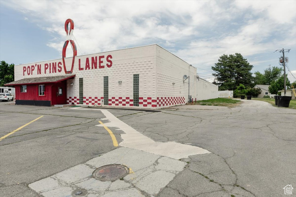View of property featuring uncovered parking