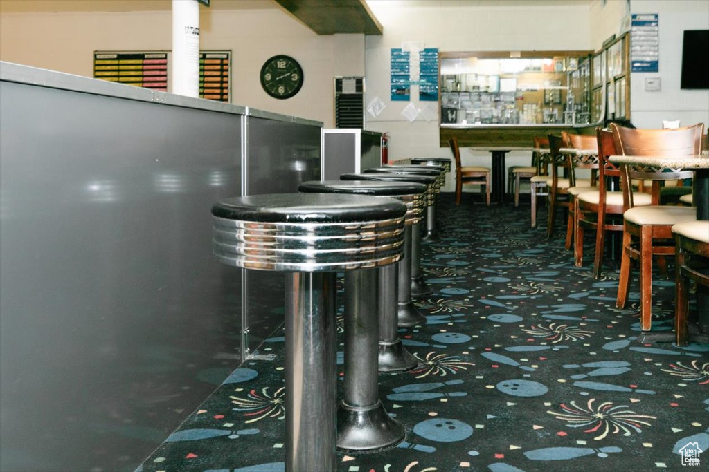 Interior space featuring a bar and carpet flooring