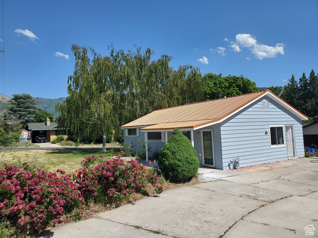 View of side of home with a metal roof