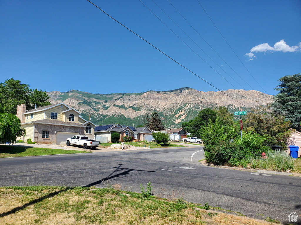 View of asphalt street featuring a mountain view