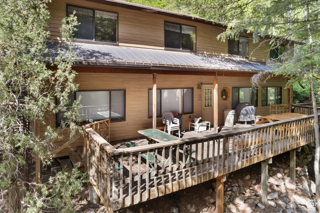 Rear view of house with a metal roof and a deck