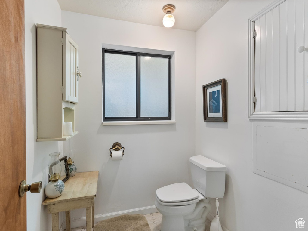 Bathroom featuring toilet and baseboards