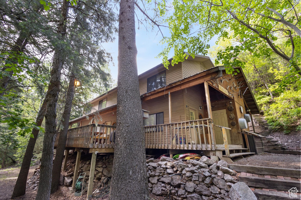 Rear view of house featuring a wooden deck