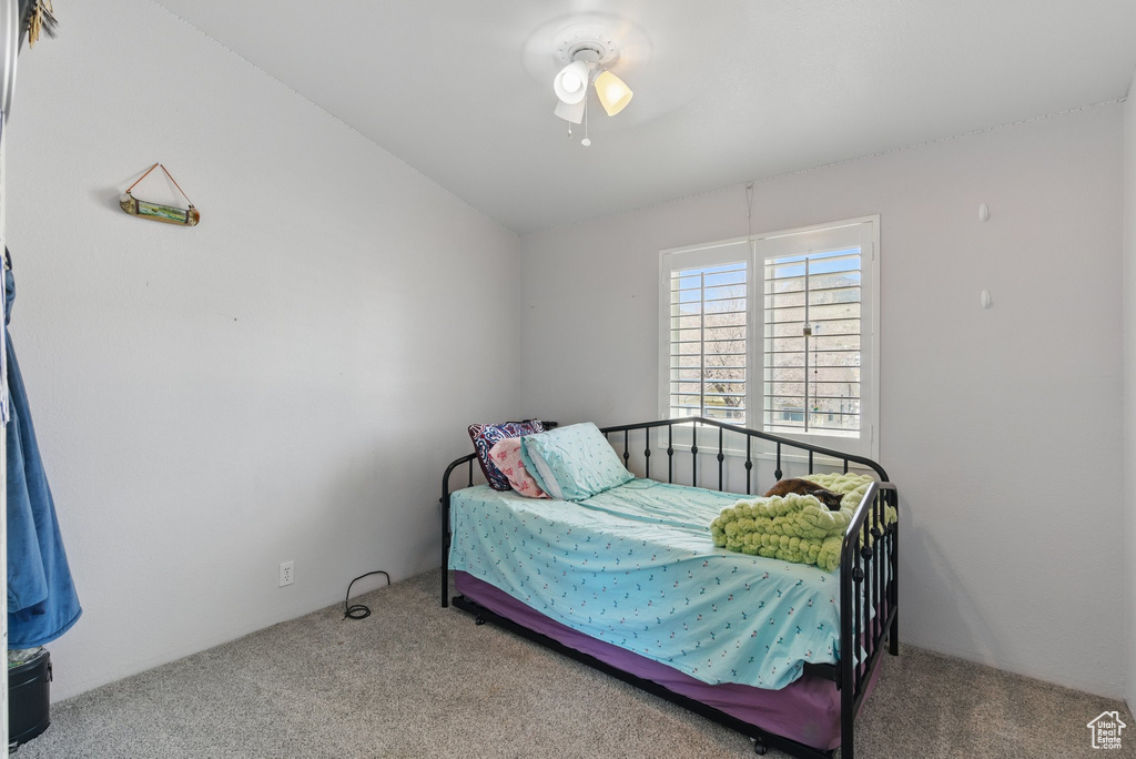 Bedroom with carpet floors, lofted ceiling, and ceiling fan