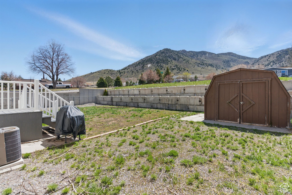 Fenced backyard with a mountain view and a storage shed