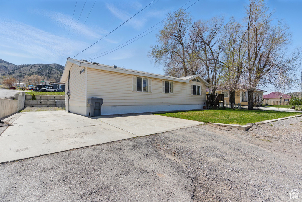 View of property exterior featuring a mountain view and crawl space