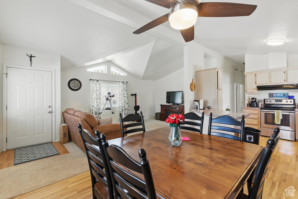Dining room with light wood-style floors and a ceiling fan