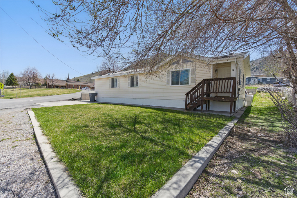 View of property exterior featuring a yard