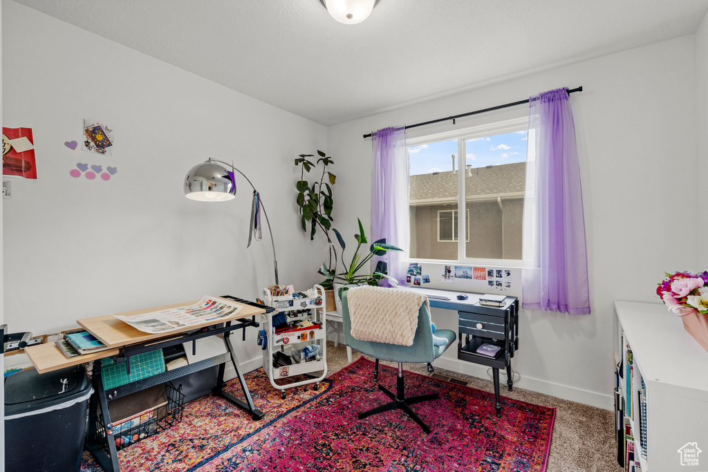 Carpeted home office with baseboards