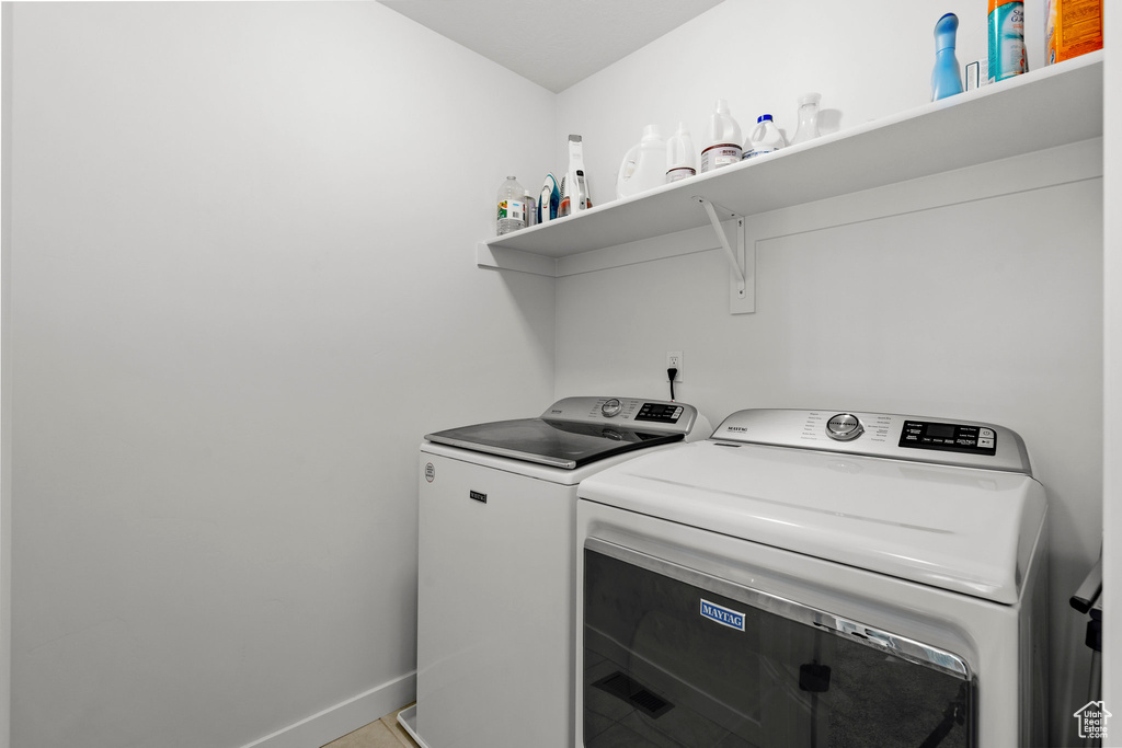 Laundry room featuring separate washer and dryer and baseboards