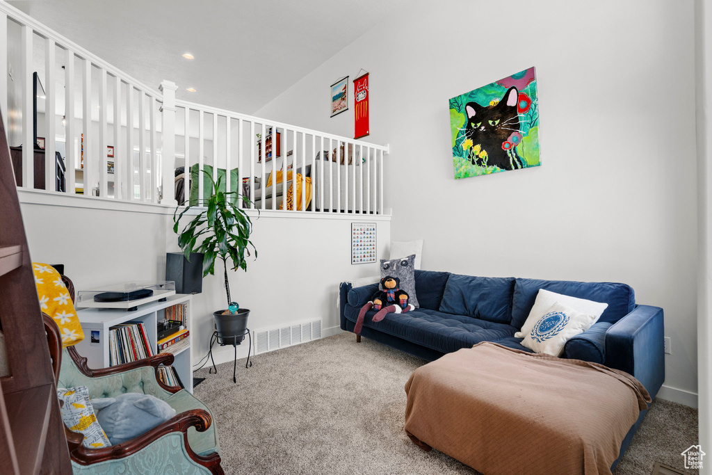 Carpeted living room with recessed lighting and baseboards