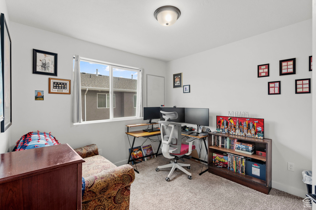 Carpeted office space featuring baseboards