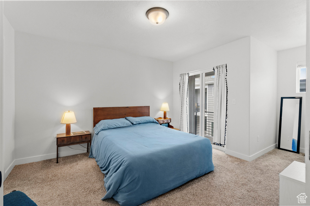 Bedroom featuring carpet flooring and access to outside