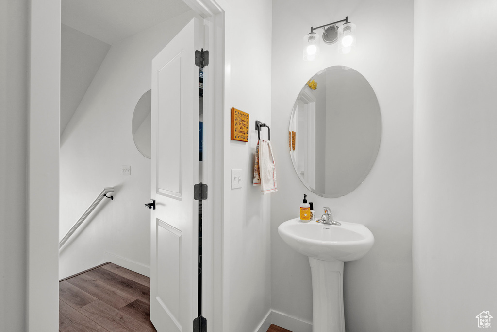 Bathroom with wood finished floors and baseboards