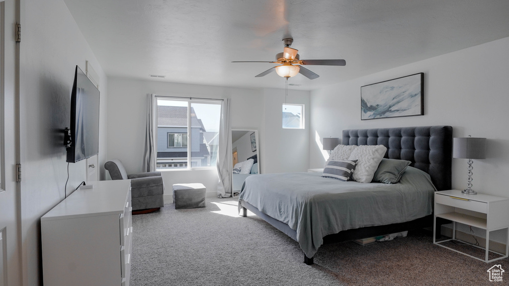 Carpeted bedroom with ceiling fan