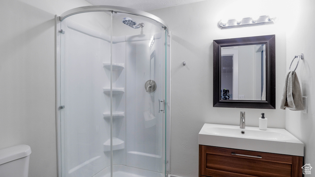 Full bathroom with vanity and a stall shower