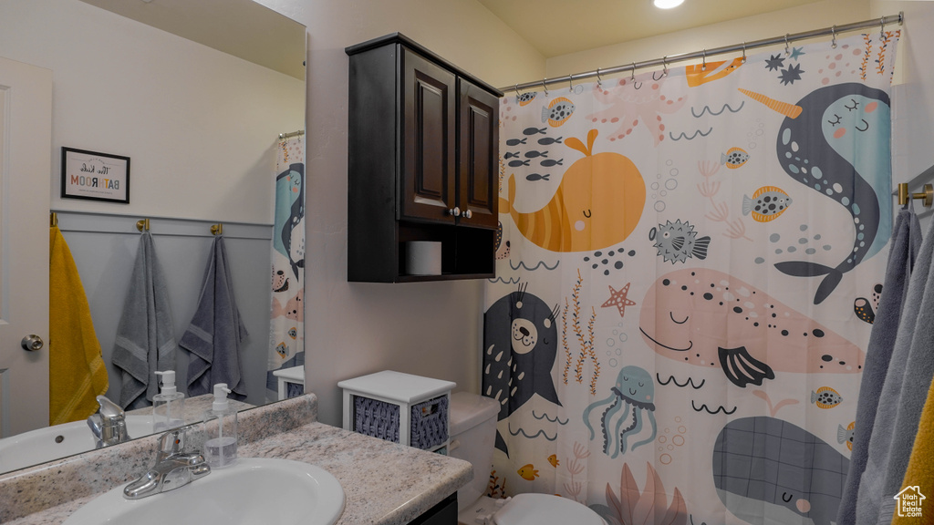 Bathroom with vanity and curtained shower