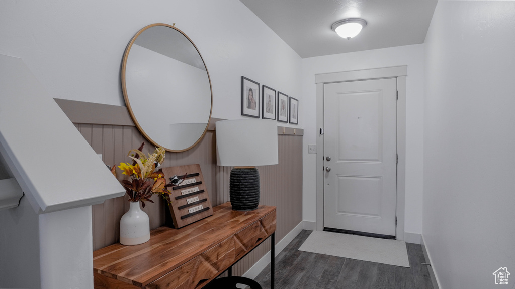 Entrance foyer with dark wood-style floors and baseboards