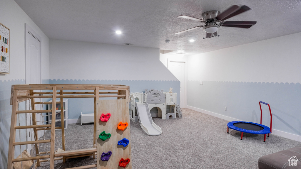 Game room featuring carpet floors, ceiling fan, a textured ceiling, and recessed lighting