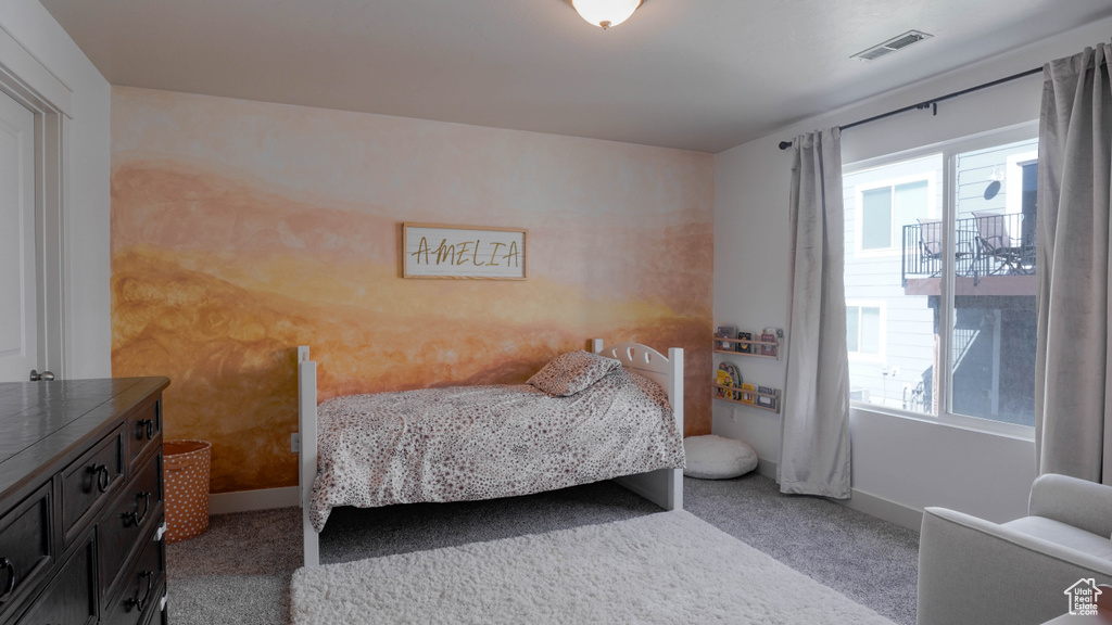 Carpeted bedroom with multiple windows