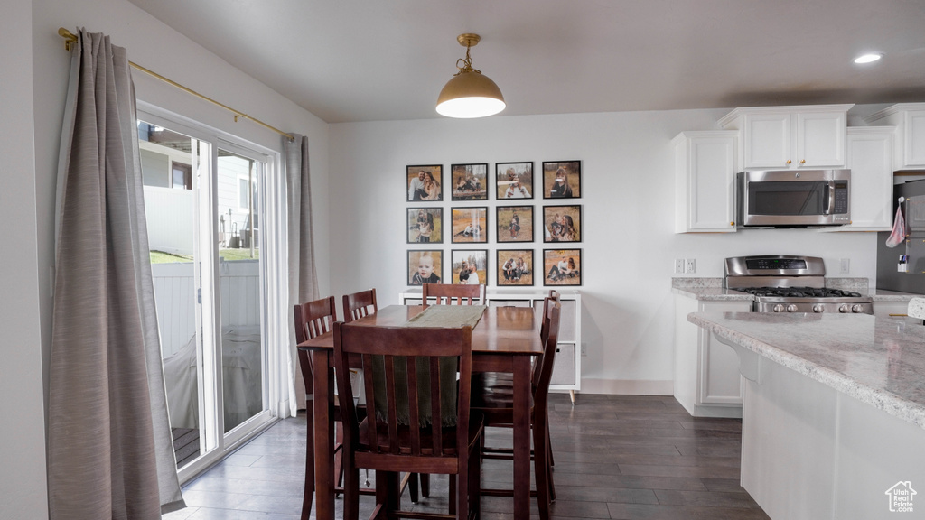 Dining space featuring dark wood-style flooring and recessed lighting