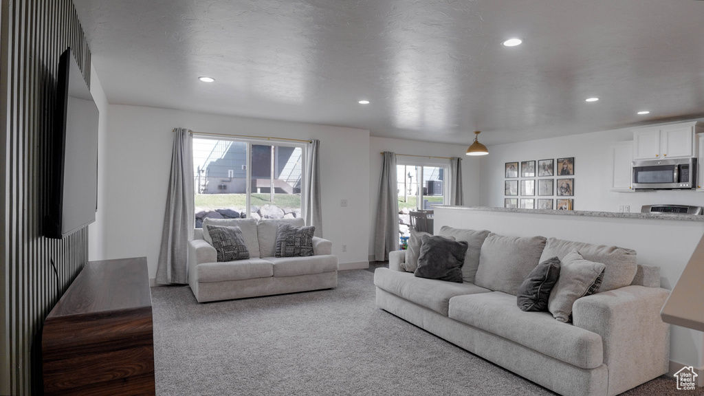 Carpeted living area featuring recessed lighting