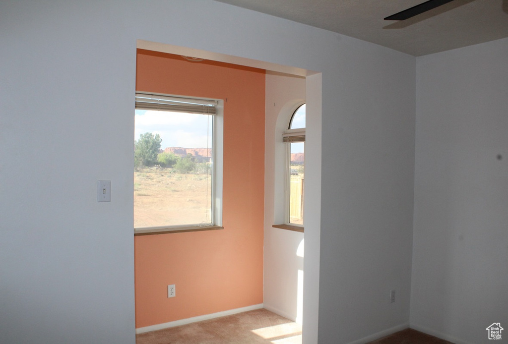 Empty room featuring carpet flooring and ceiling fan
