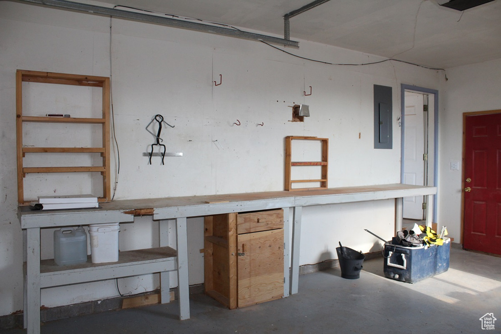 Garage featuring a workshop area and electric panel
