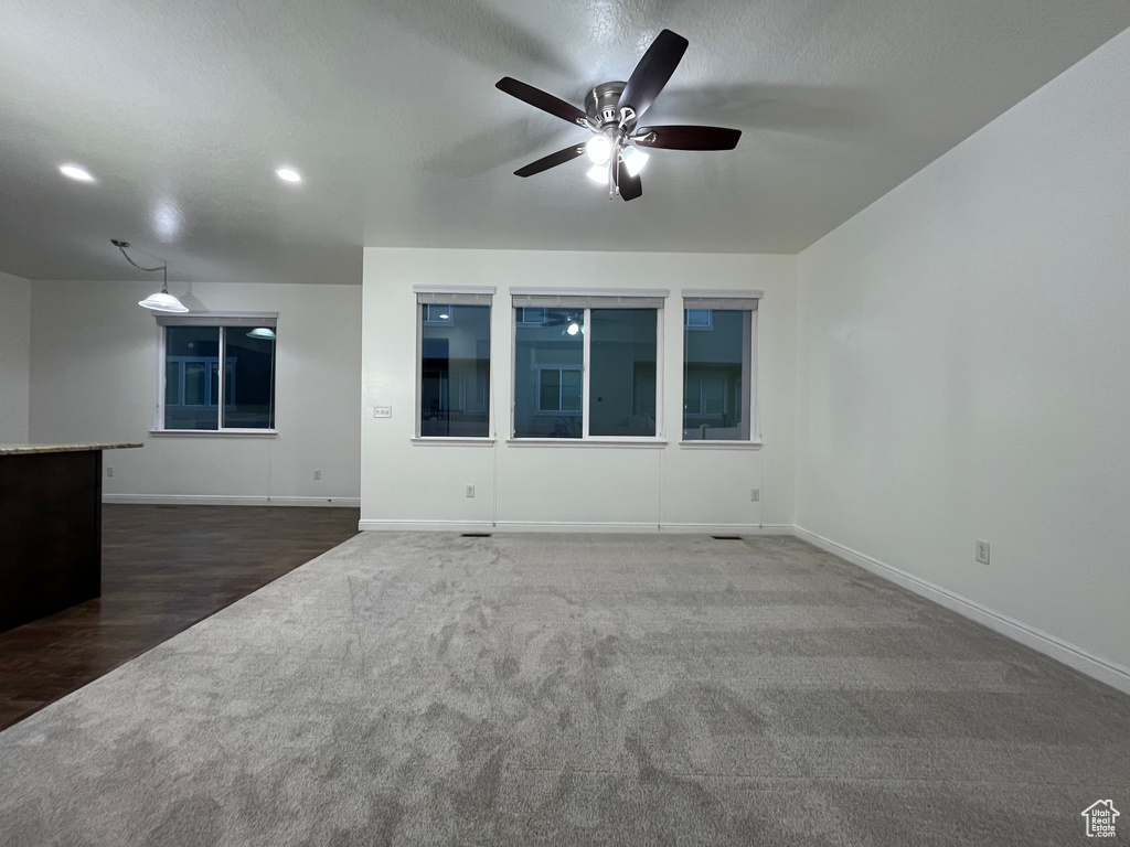 Carpeted spare room with ceiling fan, recessed lighting, and wood finished floors