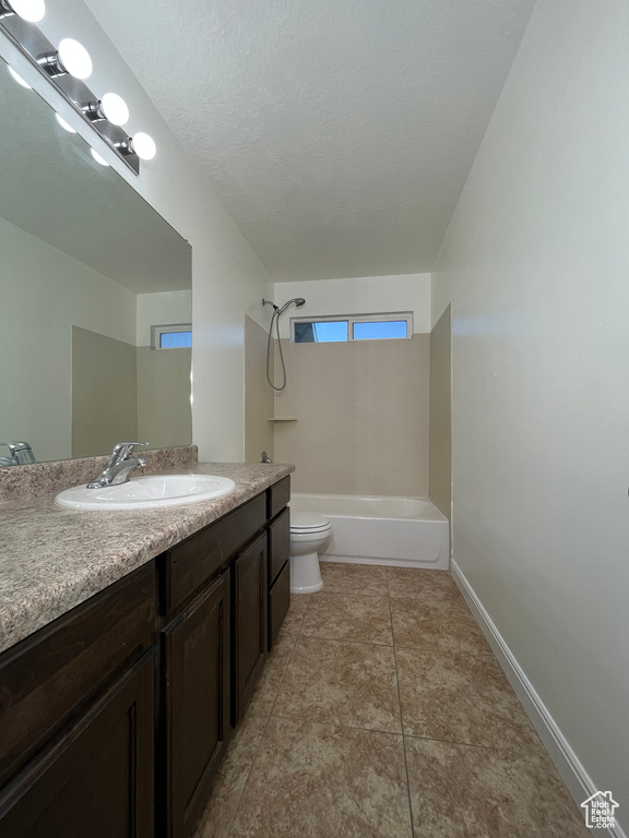 Full bathroom with vanity, washtub / shower combination, and tile patterned floors