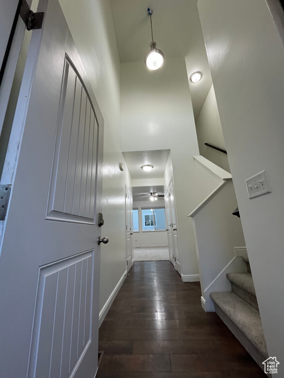 Hallway with dark wood finished floors and stairs