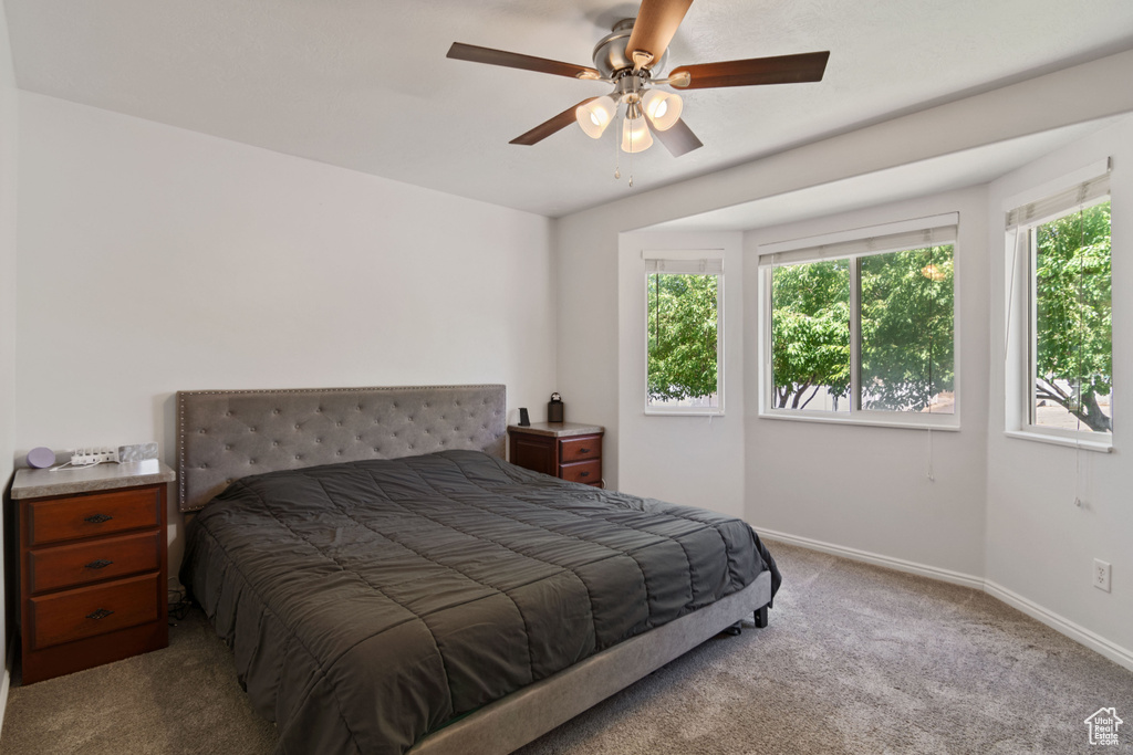 Bedroom with carpet floors and a ceiling fan